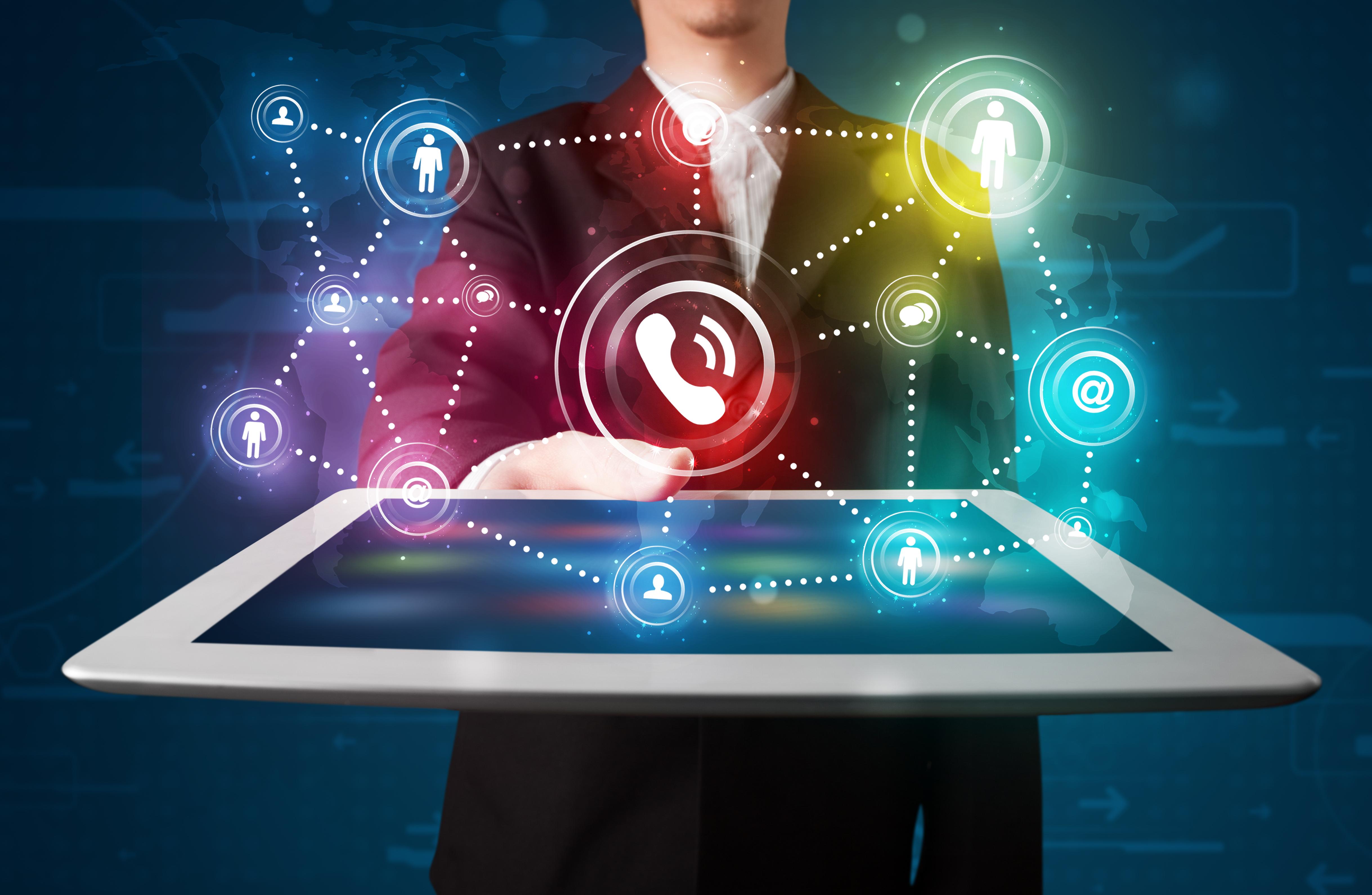 Digital network connections visualised above a tablet held in an office