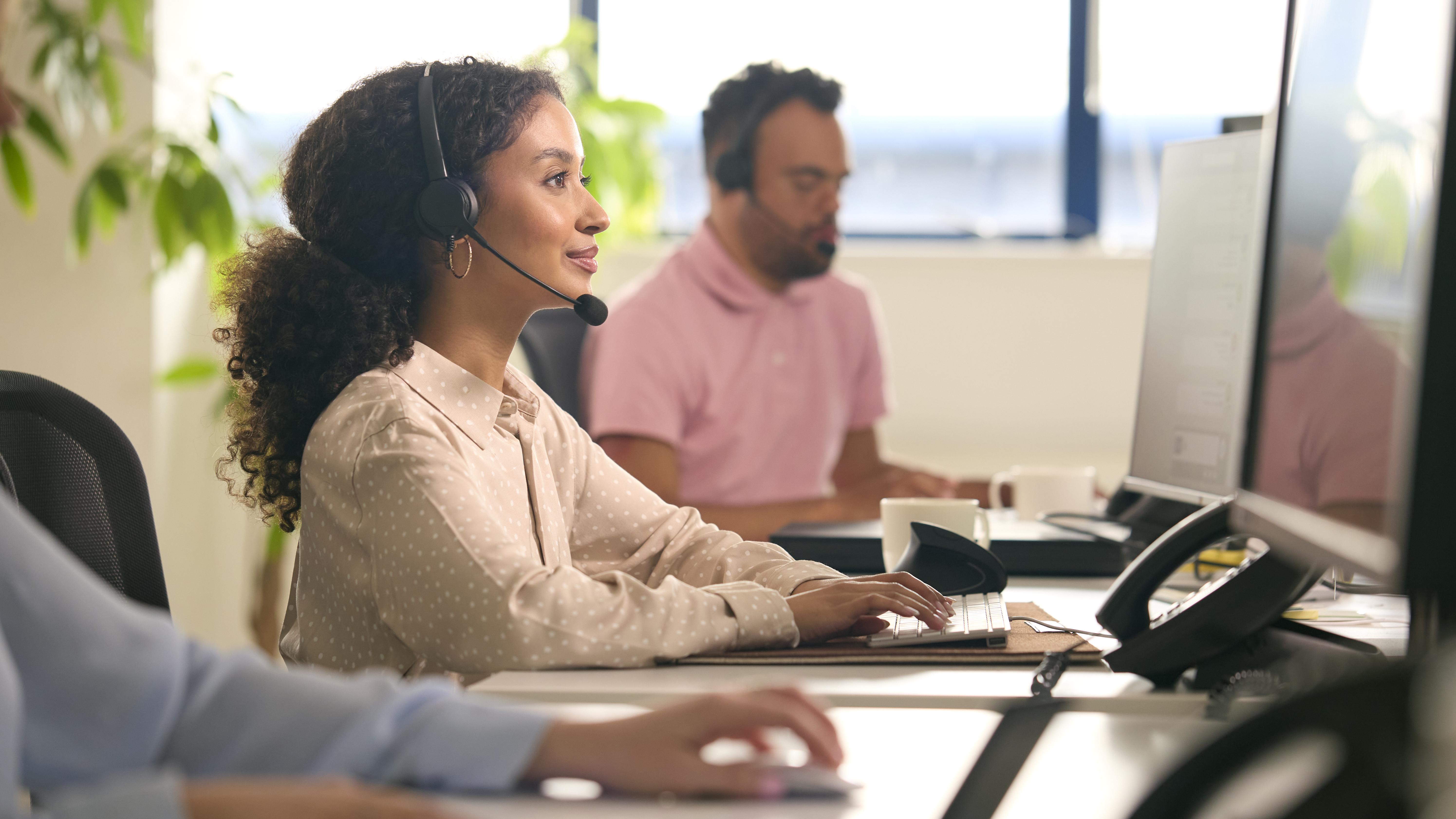 Your Communications support team member taking a customer call at her desk